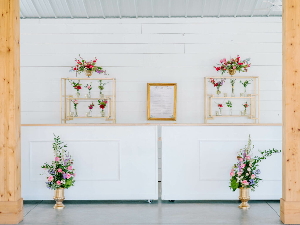 white wedding bar with gold bar back displays with flower vases