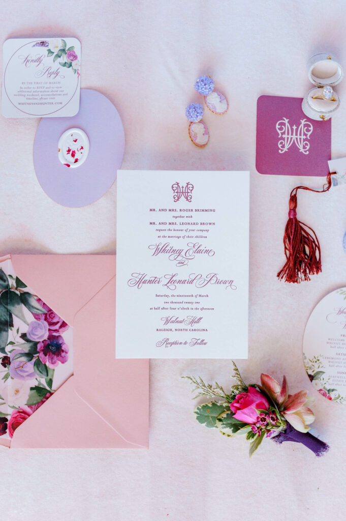 purple letterpress wedding invitation flat lay