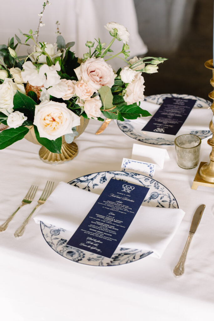blue and white chinoiserie plate wedding place setting with navy dinner menu