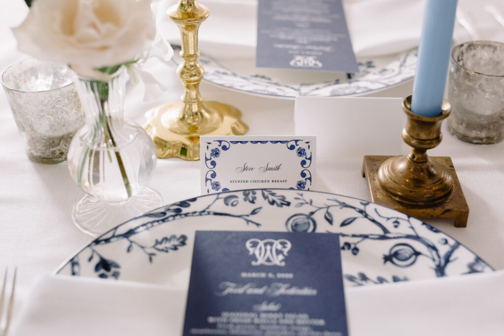blue and white close up place setting with menu card and place card