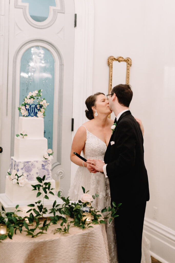 merrimon wynne couple kissing after cake cutting