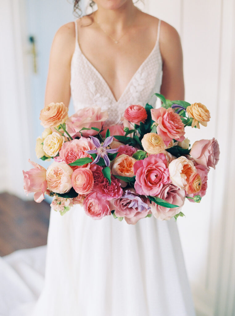 colorful bridal bouquet with pink peach  orange and purple