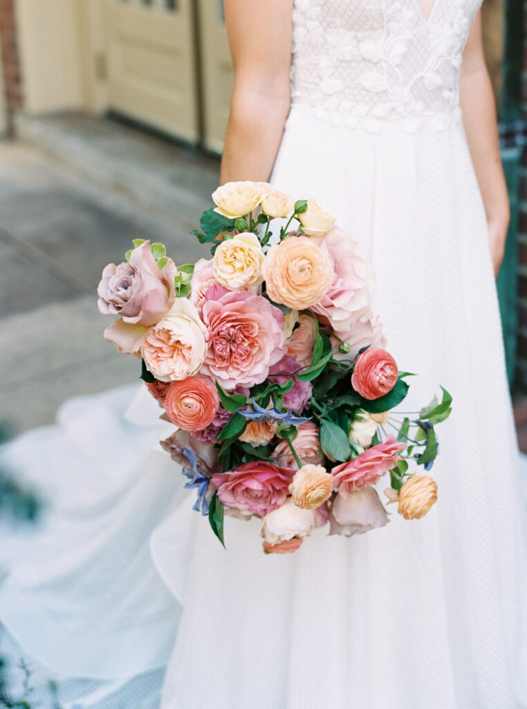 colorful bridal bouquet shot with orange peach pink and purple