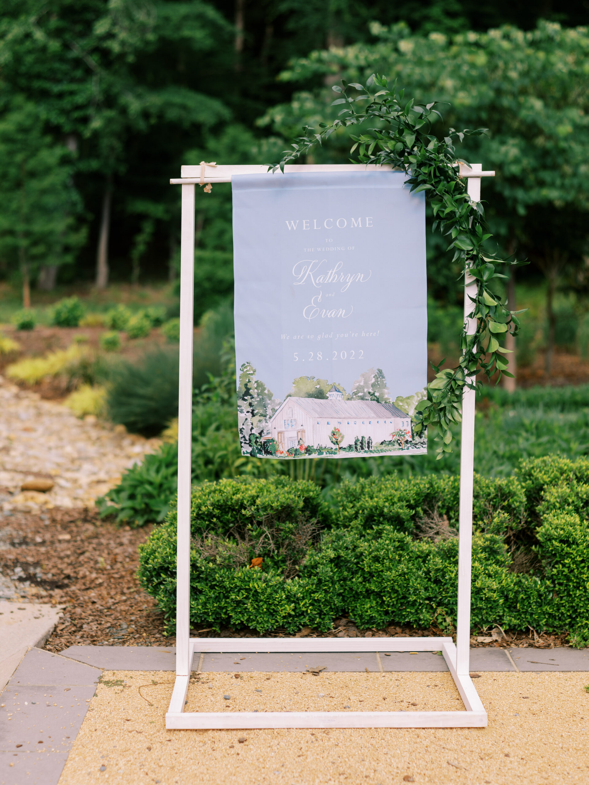 white and blue hanging fabric welcome sign