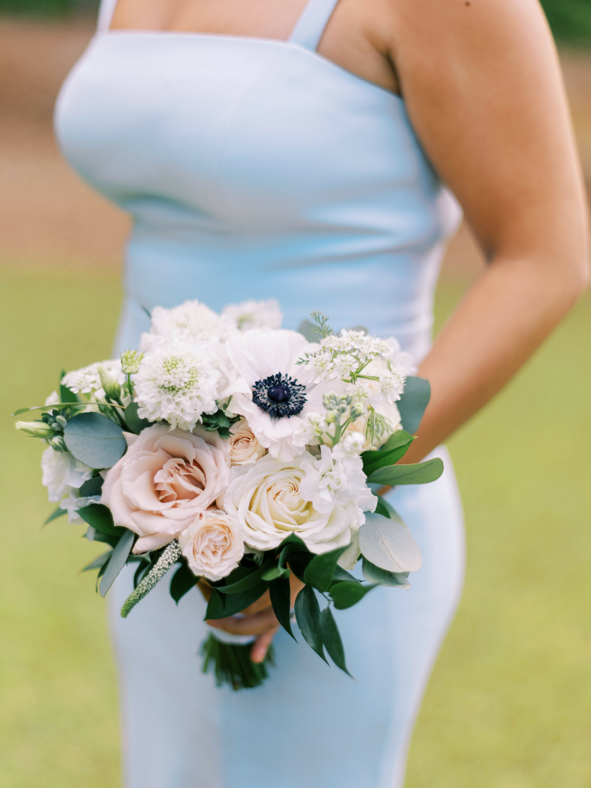 light blue bridesmaids dress holding white bouquet