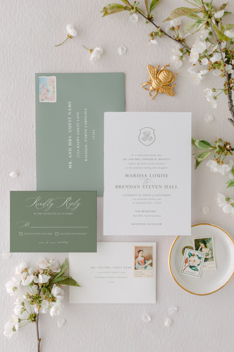 green and white wedding invitation with rsvp card and envelopes