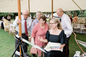 guests watch live wedding painting