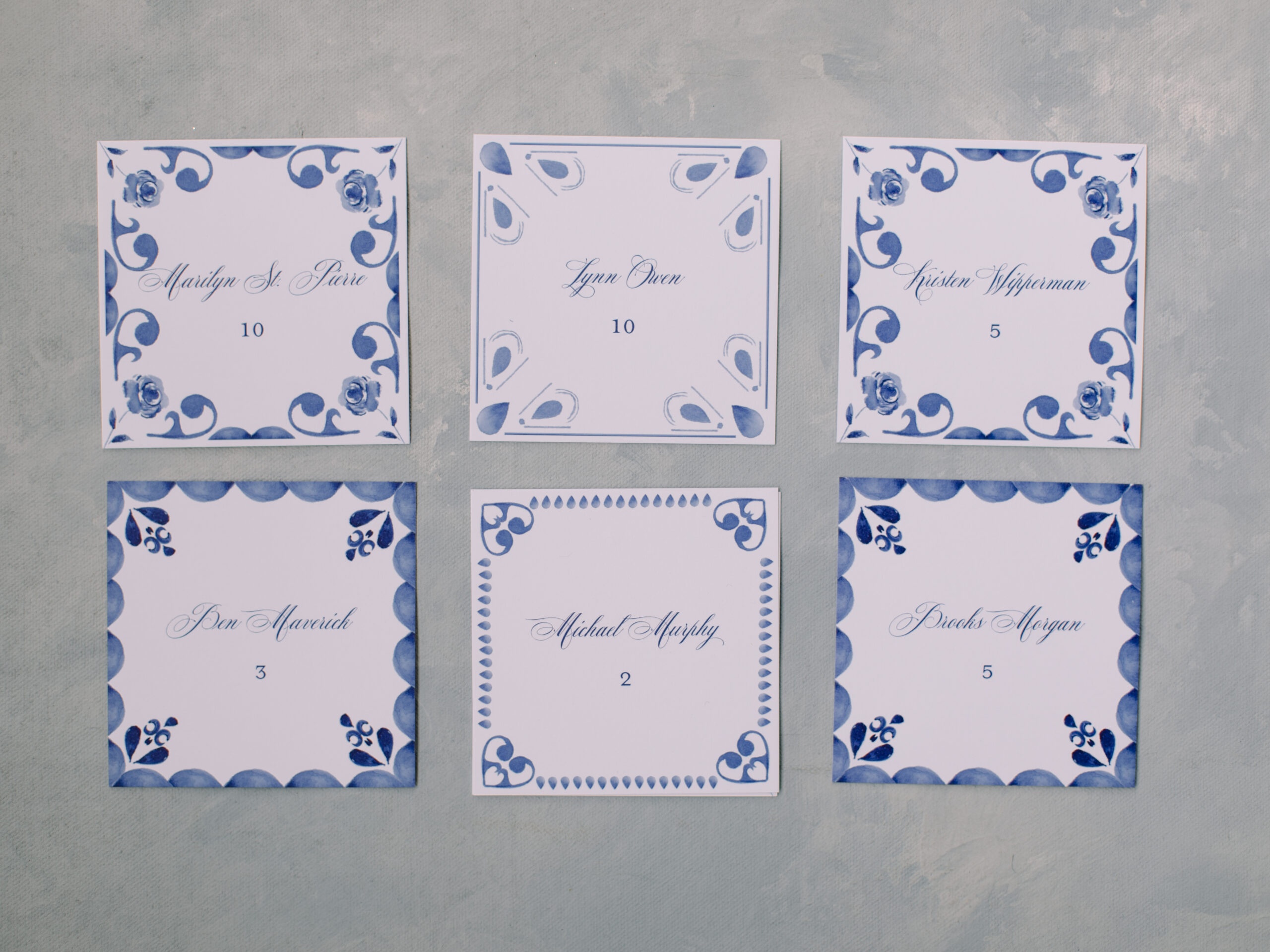 blue and white escort cards for a wedding