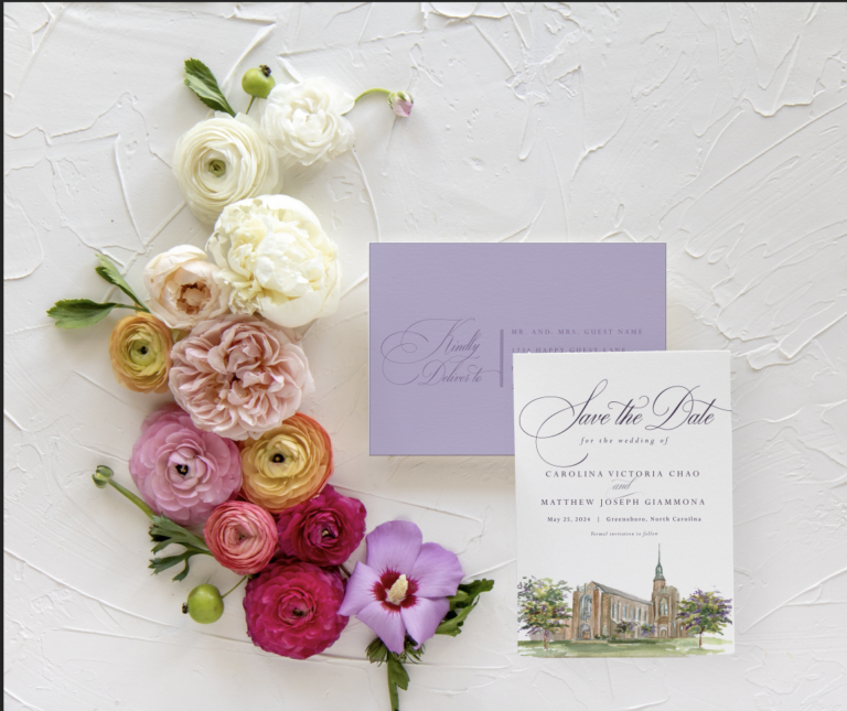 our lady of grace watercolor save the date with purple background on a white flatlay background and colorful flowers