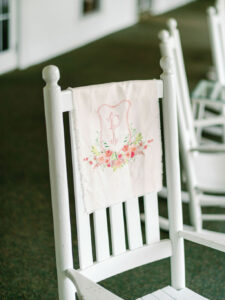 custom watercolor crest linen fabric on a rocking chair at a Pinehurst Resort wedding