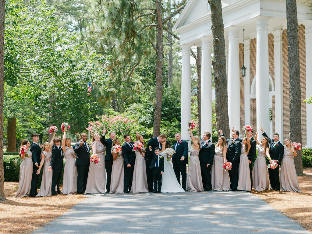 Large wedding party photo outside of chapel in Pinehurst NC