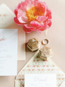 engraved tan velvet ring box with wedding invitation and pink peony for Pinehurst Resort wedding