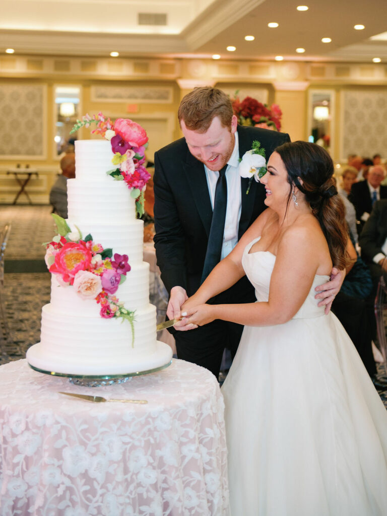 Couple cuts their cake at their Pinehurst resort wedding
