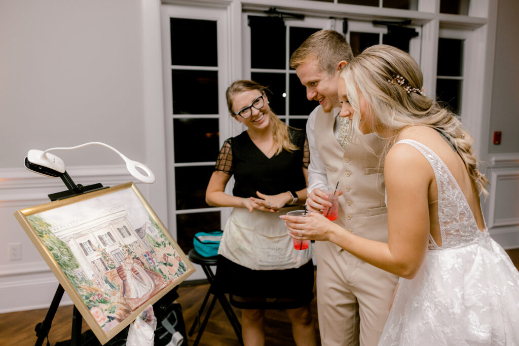 north carolina live painter showing her couple the final live painting