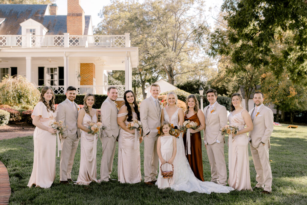 wedding party posing in front of the Rose Hill Estate