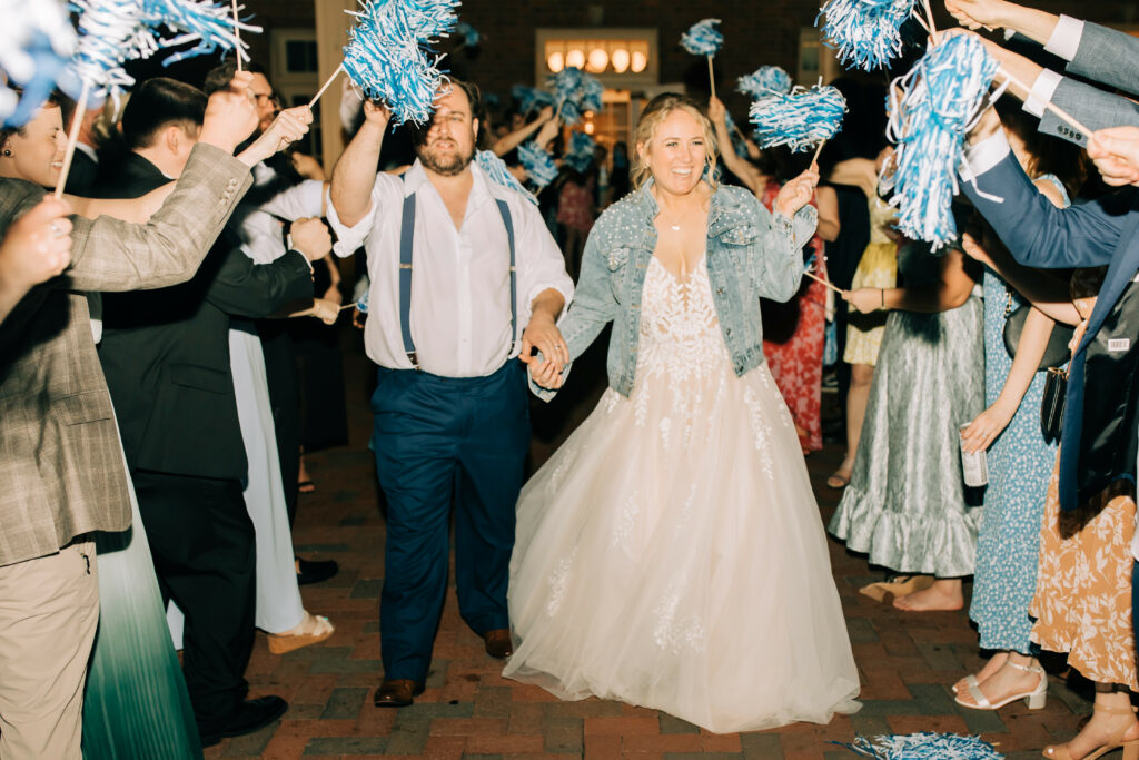 grand exit with blue and white pom poms at Carolina Inn wedding