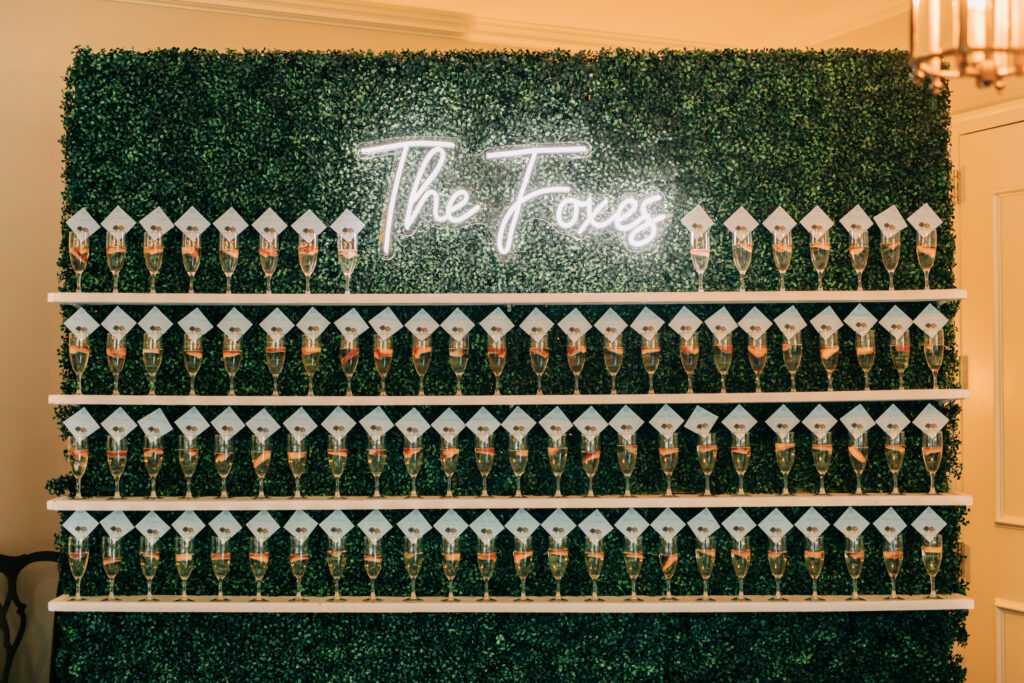 boxwood wall champagne display at wedding