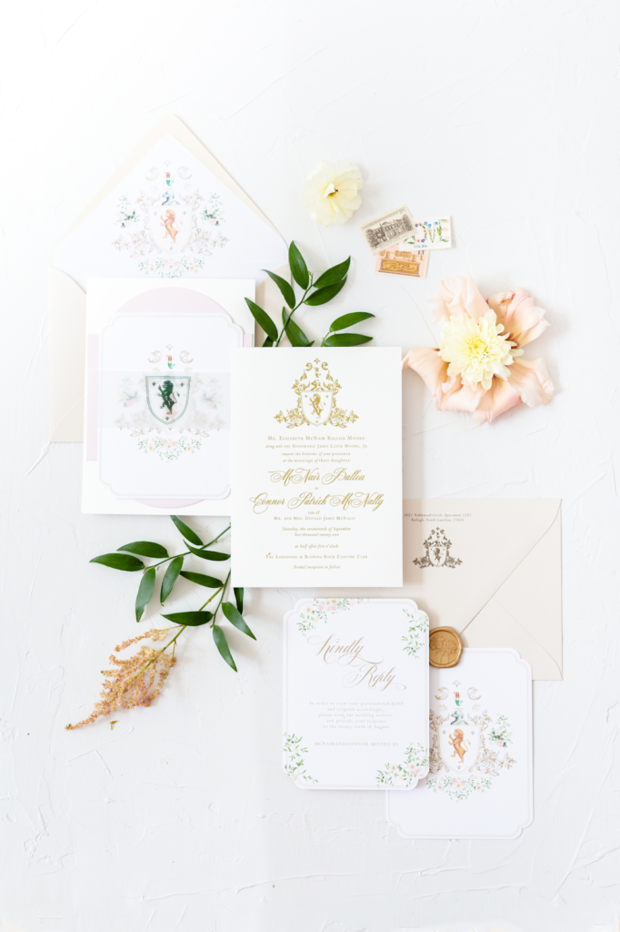 Stationer explains top trends for wedding stationery for 2023. Image shows flat lay for regal wedding invitation suite.