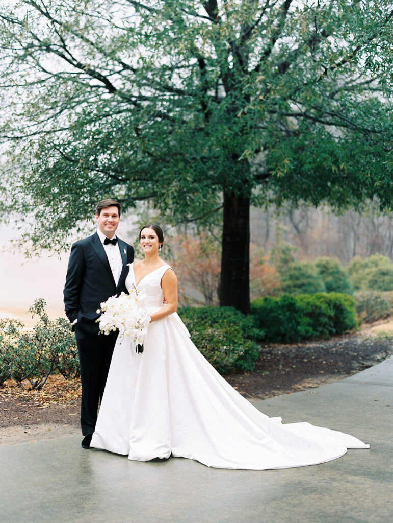 bride and groom pose outside for New Year's Eve wedding