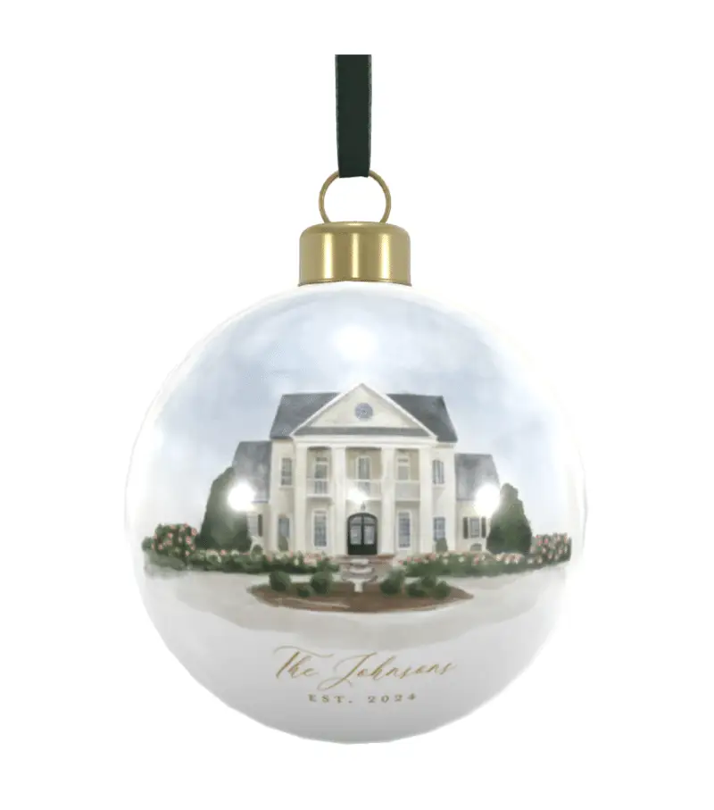 a Christmas ornament with dark green velvet ribbon and wedding venue illustration