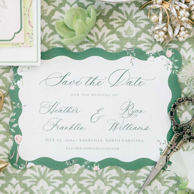 chinoiserie wedding stationery on green background with various Bridgeton inspired decorative objects