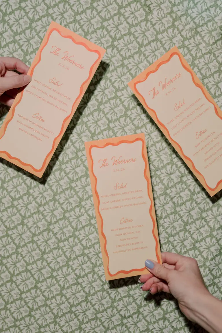 bright orange dinner menus at duke mansion wedding in three hands